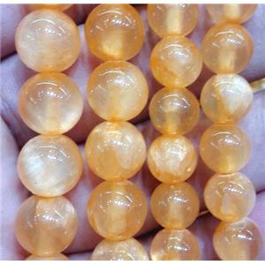 round jade beads, orange dye, approx 8mm dia